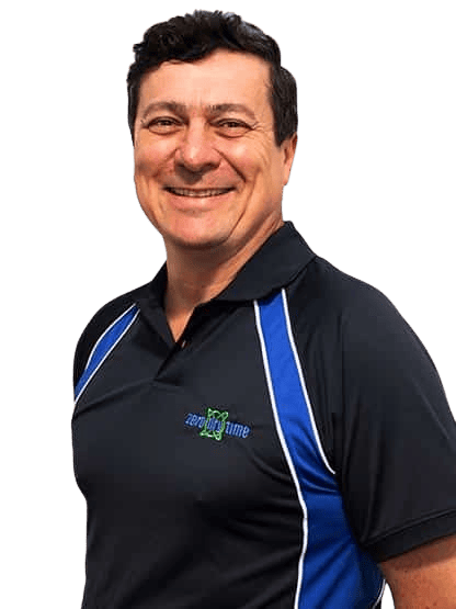 Zero Dry Time Man smiling, wearing a black and blue collared shirt with "Zero Dry Time" logo, standing against a plain background.