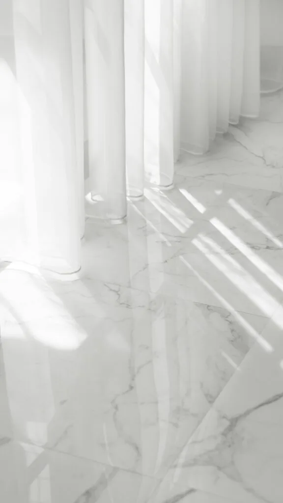 Zero Dry Time Sunlight casting shadows through sheer white curtains onto a glossy white marble floor