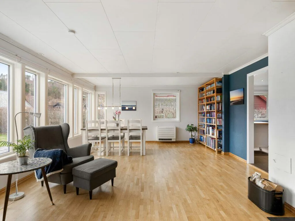 Zero Dry Time Bright living and dining area with large windows and light wood flooring